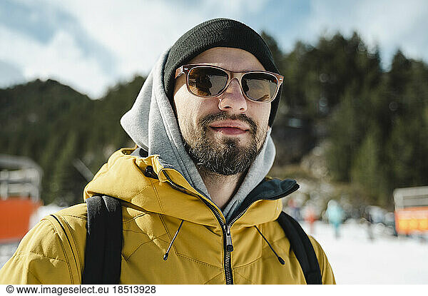 Smiling man wearing sunglasses at ski resort