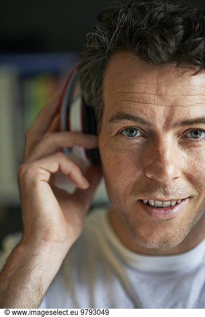 Smiling man with headphones on  close up