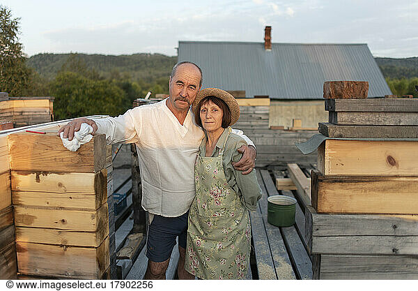 Smiling man with woman standing at construction site