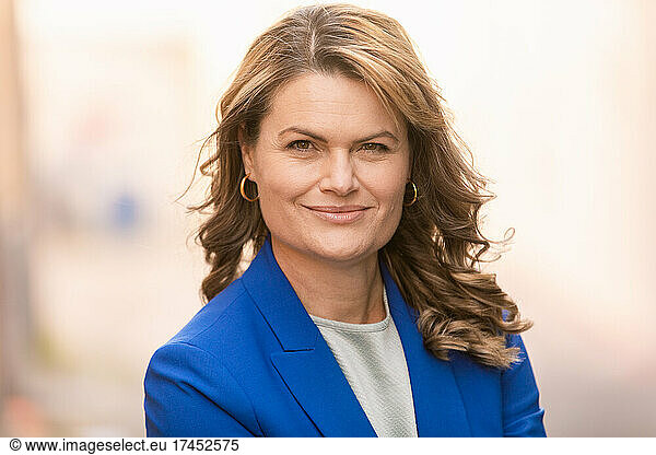 Smiling mature businesswoman in blue suit