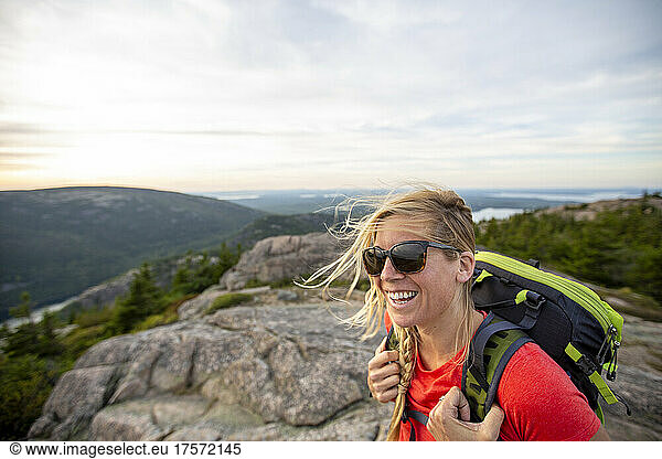 Smiling mid adult woman hikes in Acadia National Park  Maine