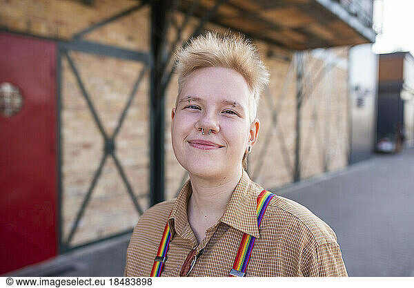Smiling non-binary person wearing nose ring on street