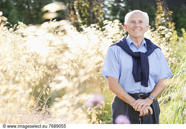 Smiling older man standing outdoors