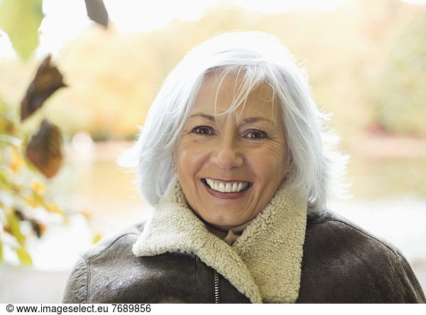 Smiling older woman standing outdoors