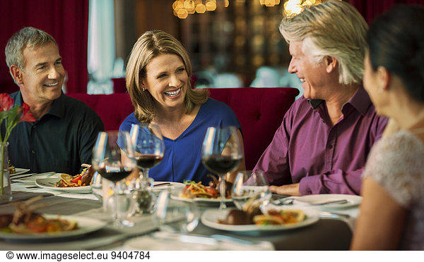 Smiling people enjoying their meal in restaurant