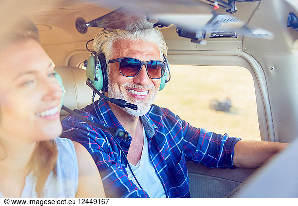 Smiling pilot flying airplane