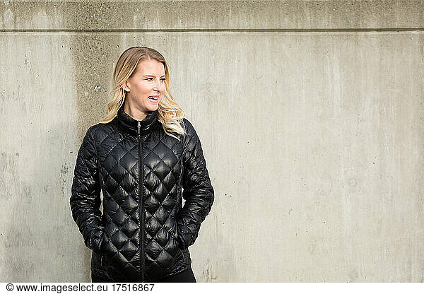 Smiling portrait of pretty blonde woman in quilted jacket