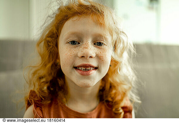 Smiling redhead girl with freckles