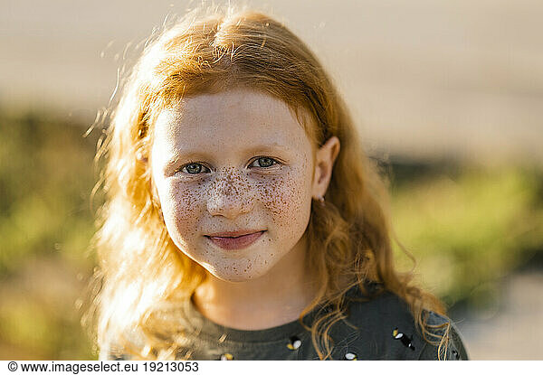Smiling redhead girl with freckles