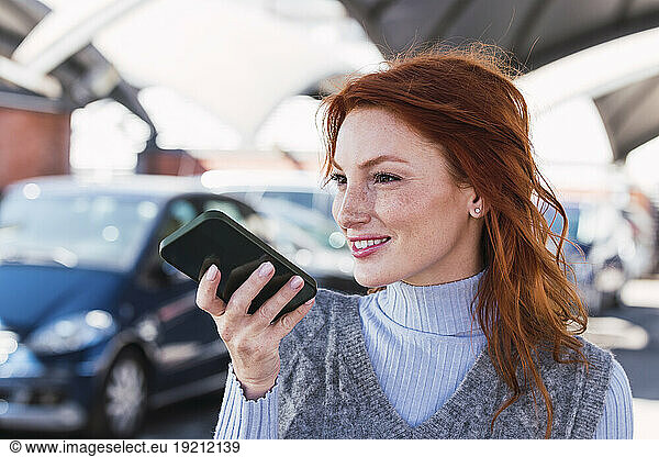 Smiling redhead woman talking on mobile phone