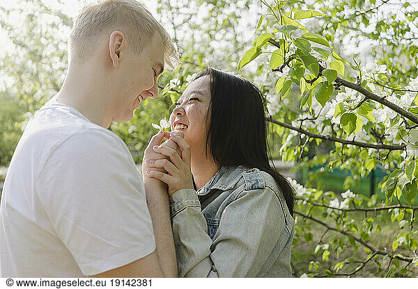Smiling romantic couple looking at each other in park