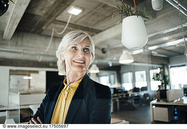 Smiling senior businesswoman with blazer at office