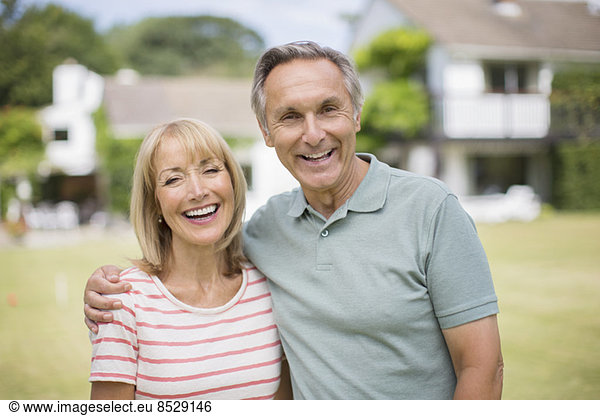 Smiling senior couple hugging outdoors