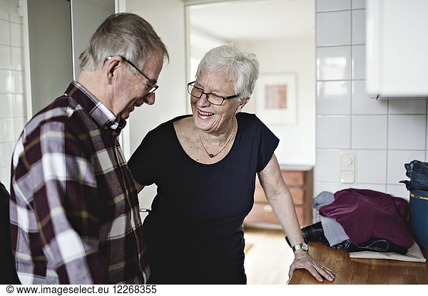 Smiling senior couple standing in bathroom at home