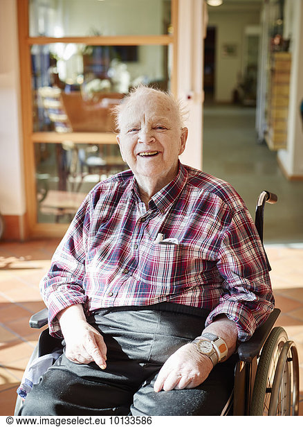 Smiling senior man on wheelchair