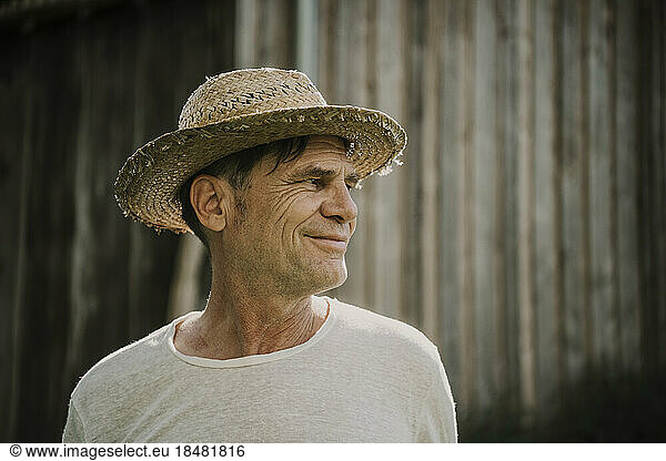Smiling senior man wearing straw hat