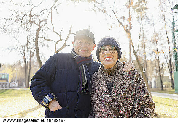 Smiling senior man with woman at autumn park
