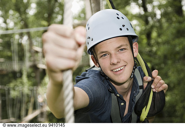 smiling teenager in a climbing crag  close-up