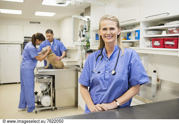 Smiling veterinarian standing in vet's surgery