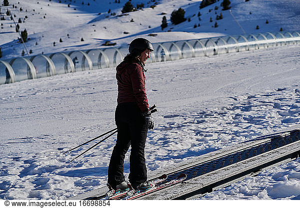 smiling woman climbs the runway in a skier tape