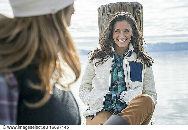 Smiling woman hanging out on pier with her friend