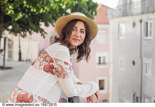 Smiling woman in a straw hat looking in the camera in Lisbon  Portugal