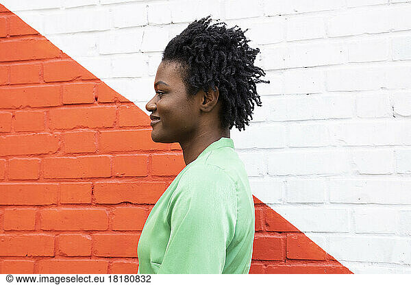 Smiling woman in front of red and white wall