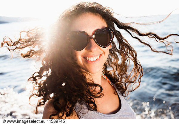 Smiling woman in sunglasses on beach