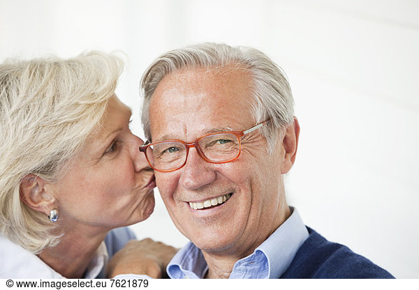 Smiling woman kissing husband