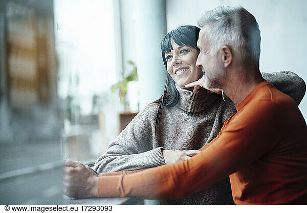 Smiling woman leaning on man at coffee shop