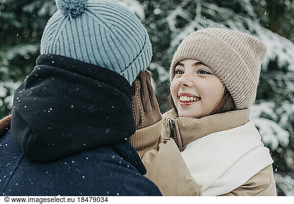 Smiling woman looking at boyfriend in park