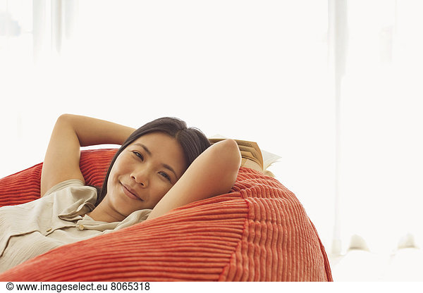 Smiling woman relaxing in beanbag chair