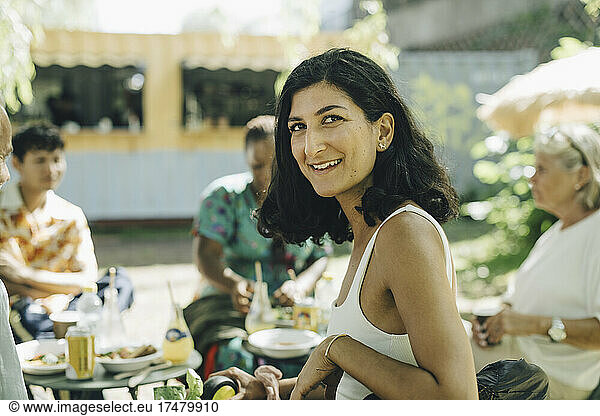Smiling woman sitting customers while having having street food