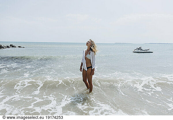 Smiling woman standing at beach