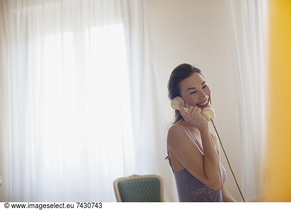Smiling woman talking on telephone