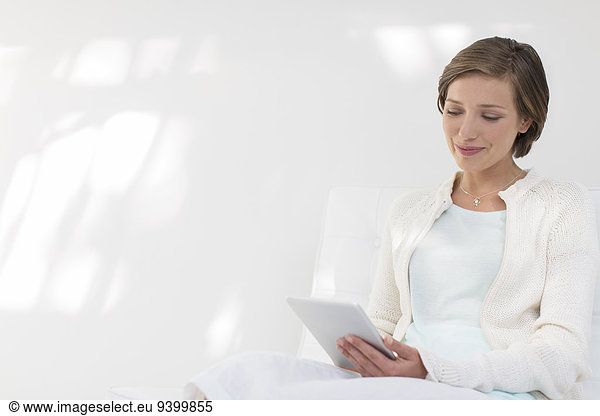 Smiling woman using digital tablet