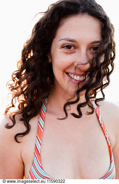 Smiling woman wearing bikini outdoors