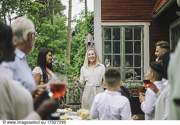Smiling woman welcoming family members at party
