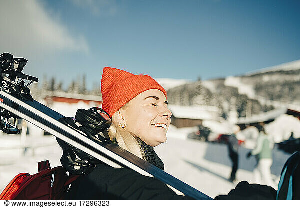 Smiling woman with eyes closed at tourist resort on sunny day