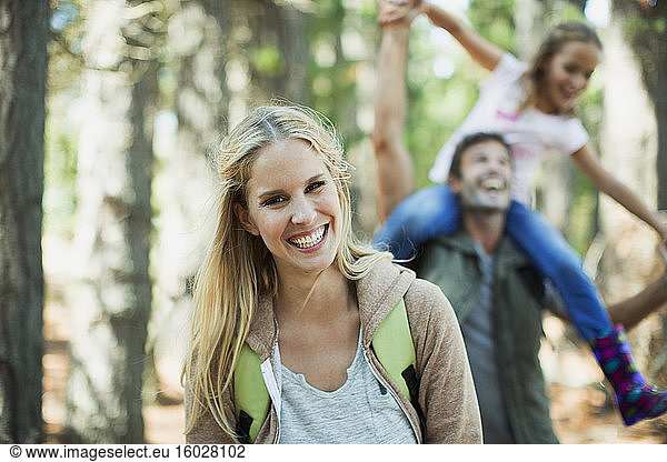 Smiling woman with family in woods
