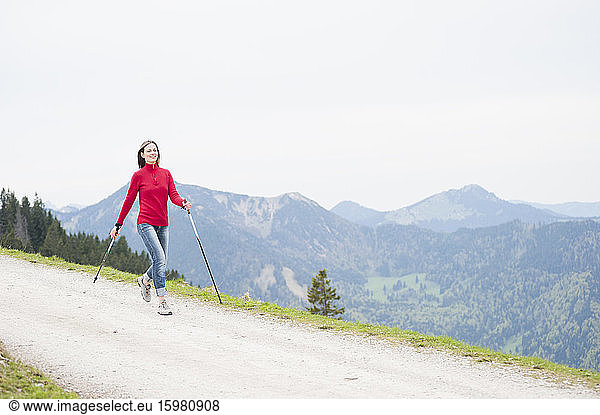 Smiling woman with hiking poles  Wallberg  Bavaria  Germany