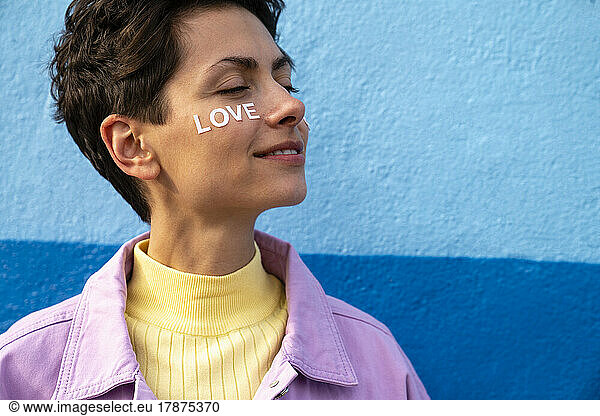 Smiling woman with love text on face