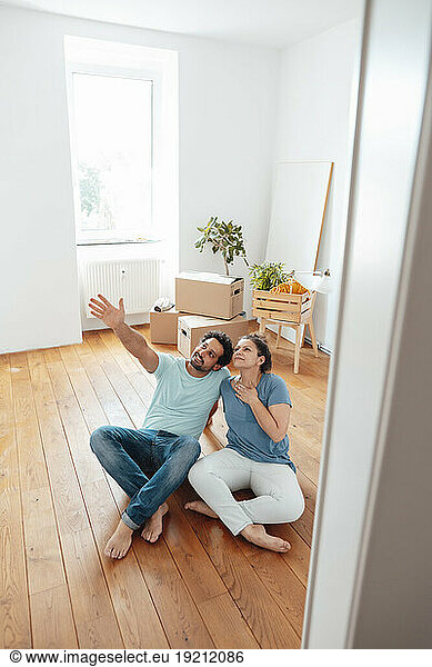 Smiling woman with man gesturing at home