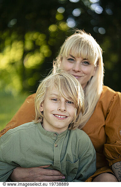 Smiling woman with son in park
