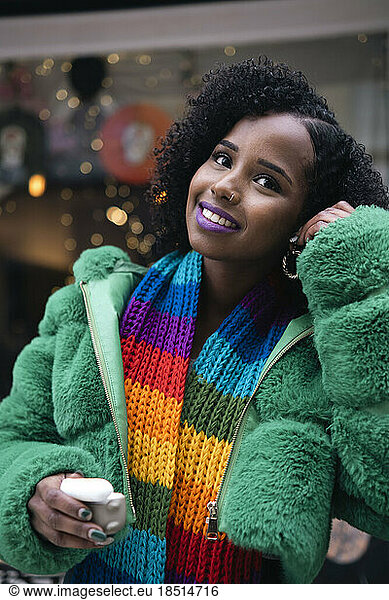 Smiling woman with wireless in-ear headphones