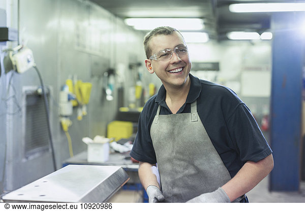 Smiling worker in steel factory