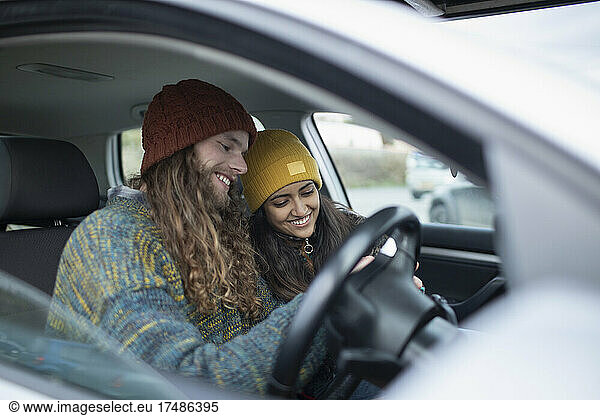Smiling young couple inside car