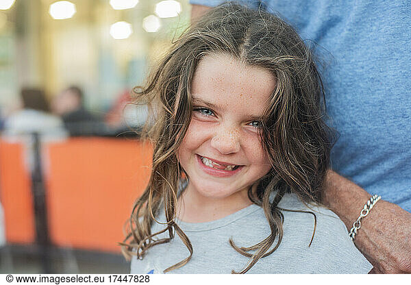 Smiling young girl with no front teeth