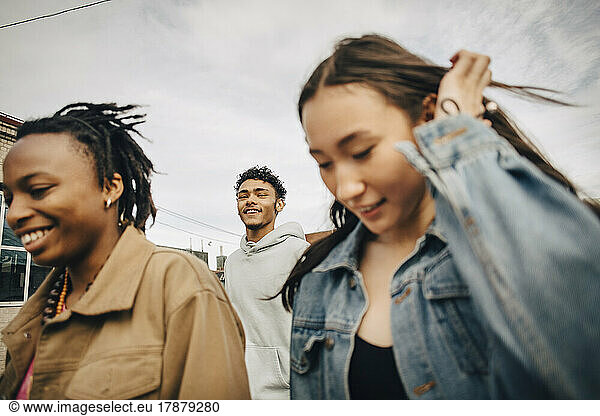 Smiling young man with multiracial female friends