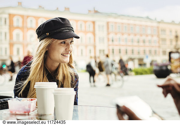 Smiling young woman sitting in cafe